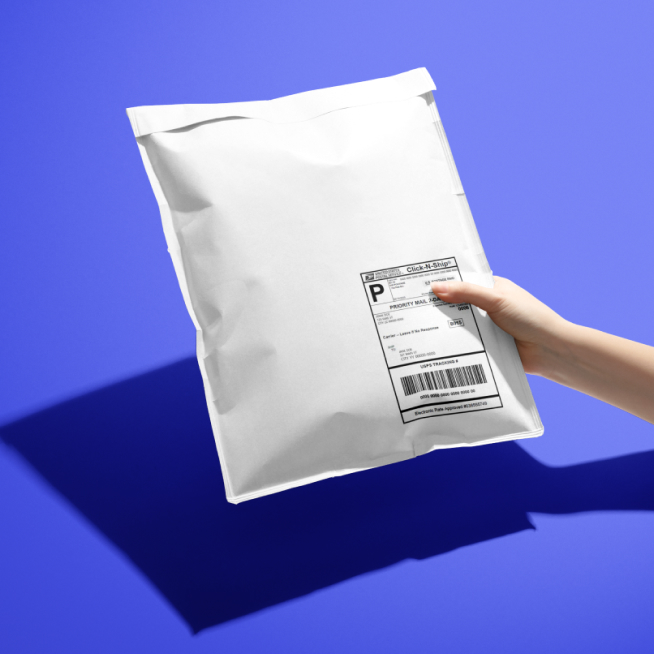 A hand holding a plain, discreet delivery package